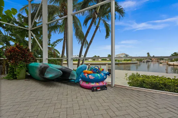 Screened waterfront lanai with palm views and family-friendly outdoor fun