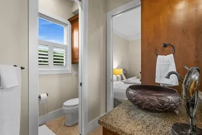 Elegant bathroom with vessel sink, granite vanity, and bright window