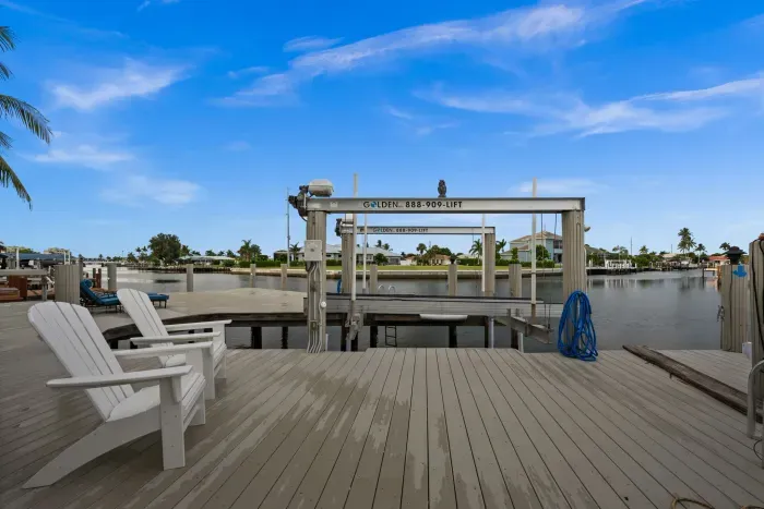 Private waterfront dock with boat lift and relaxing canal views