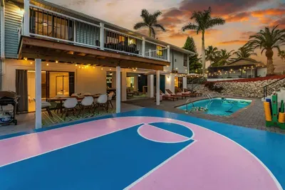 Outdoor Oasis: Dive into fun with a private pool, basketball court, and lush tropical vibes!