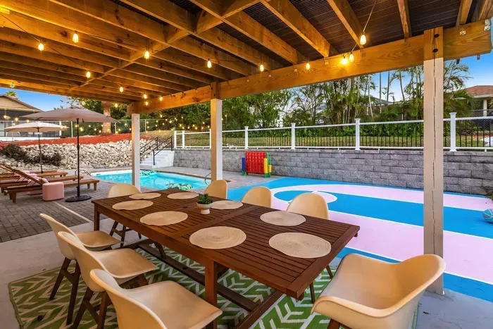 Outdoor Dining: Gather around the chic table under twinkling lights, steps from the pool!