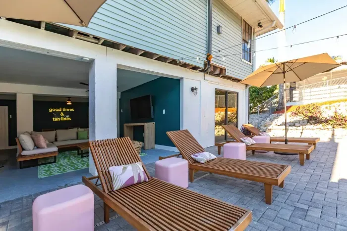 Outdoor Lounge Area: Sip cocktails under sunny skies, unwind on stylish loungers, and enjoy island vibes!