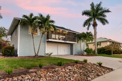 Exterior: Stunning getaway with tropical landscaping and inviting balcony views in sunny Marco Island!