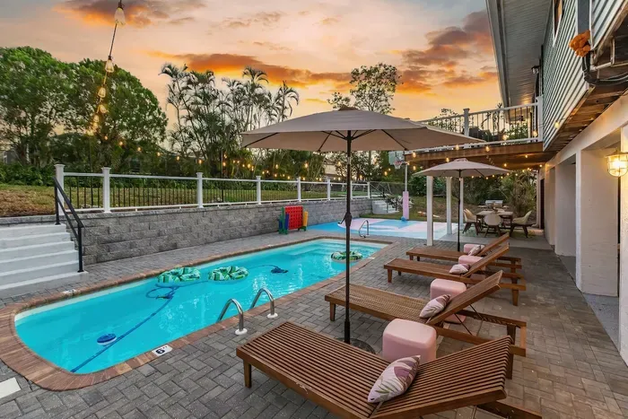 Outdoor Oasis: Relax by the pool under twinkling lights and swaying palms!