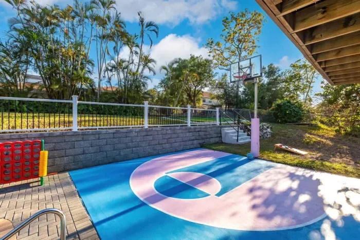 Outdoor Fun Zone: Basketball court, vibrant colors, and palm trees await your playful adventures!