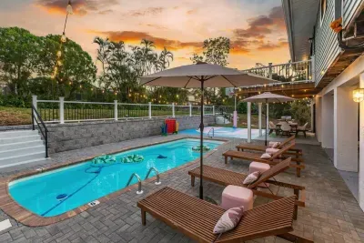Outdoor Oasis: Relax by the pool under twinkling lights and swaying palms!