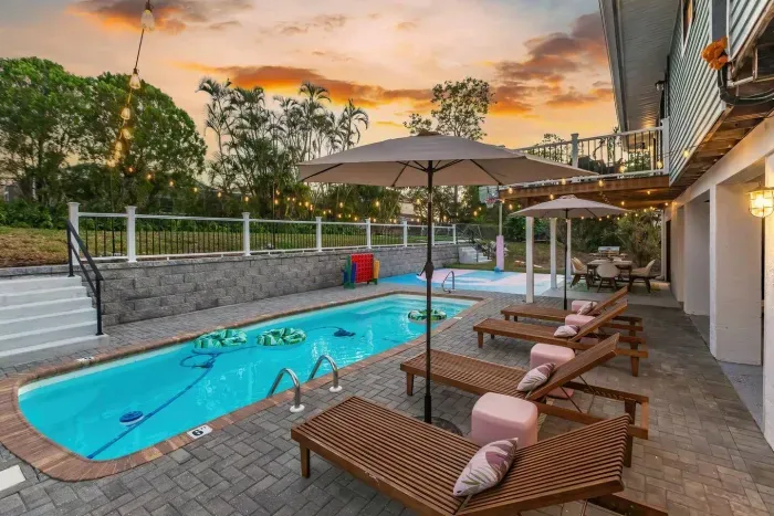 Outdoor Oasis: Relax by the pool under twinkling lights and swaying palms!