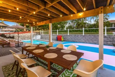 Outdoor Dining: Gather around the chic table under twinkling lights, steps from the pool!