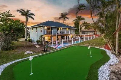 Exterior Oasis: Enjoy sunset views from your private putting green and sparkling poolside retreat!