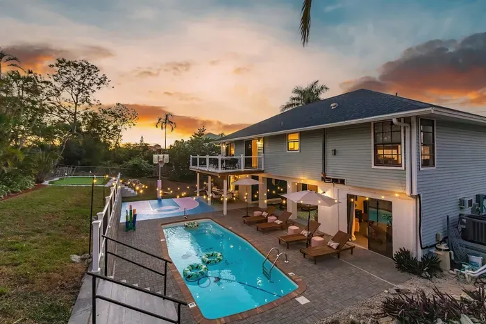 Outdoor Paradise: Dive into fun with a sparkling pool, lounge chairs, and sunset views!