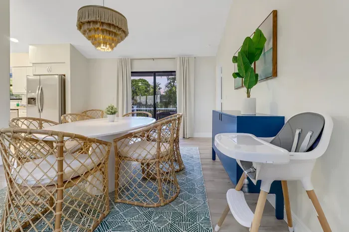 Dining Room: Bright and airy space, perfect for family meals with stylish rattan chairs!