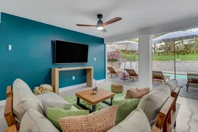Outdoor Living Room: Bright space with stylish decor and poolside views, perfect for relaxation!
