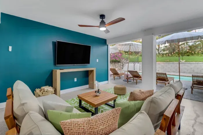 Outdoor Living Room: Bright space with stylish decor and poolside views, perfect for relaxation!
