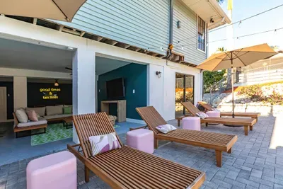 Outdoor Lounge Area: Sip cocktails under sunny skies, unwind on stylish loungers, and enjoy island vibes!