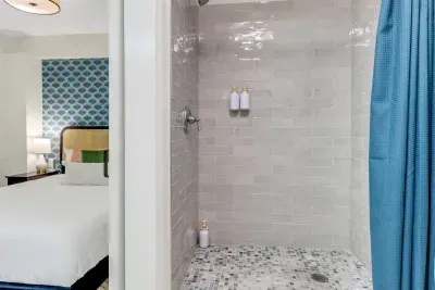 Chic Bathroom Retreat: Enjoy a refreshing shower in this stylish, modern space with elegant tile details!