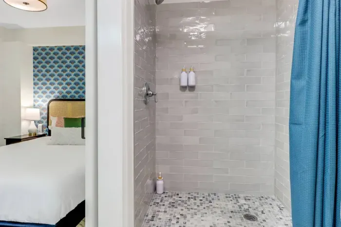 Chic Bathroom Retreat: Enjoy a refreshing shower in this stylish, modern space with elegant tile details!