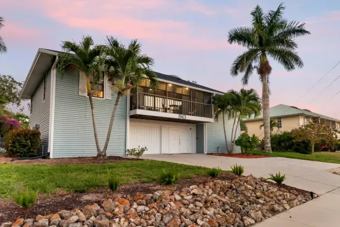 Exterior: Stunning getaway with tropical landscaping and inviting balcony views in sunny Marco Island!