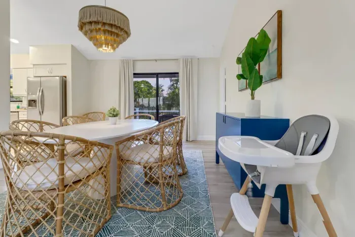 Dining Room: Bright and airy space, perfect for family meals with stylish rattan chairs!
