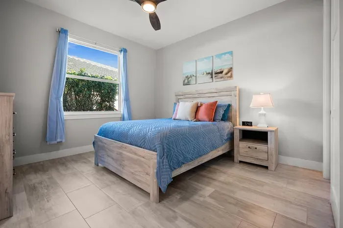 Bedroom Retreat: Bright, airy space with coastal decor and serene garden views awaits your relaxation!