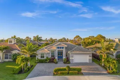 Exterior: Bright tropical oasis with lush landscaping and a welcoming entrance—your sunny escape awaits!