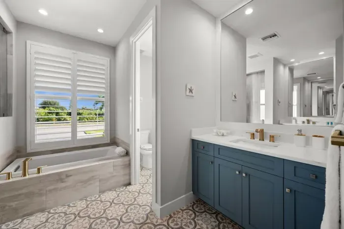 Master Bathroom: Sunlit retreat with elegant fixtures and a relaxing soaking tub for ultimate bliss!