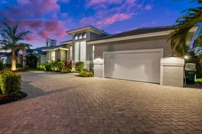 Exterior Oasis: Stunning modern design with lush landscaping and vibrant sunset views!