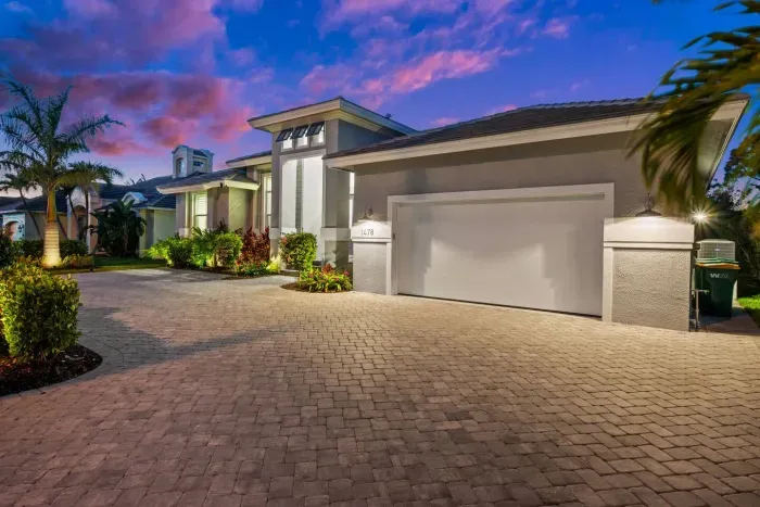 Exterior Oasis: Stunning modern design with lush landscaping and vibrant sunset views!