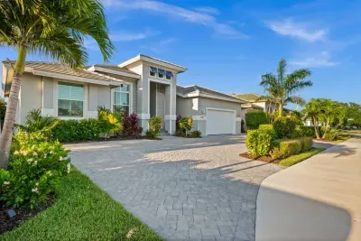 Exterior: Stunning tropical curb appeal with lush landscaping and inviting entrance awaits you!