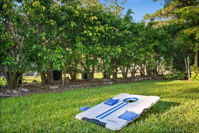 Outdoor Fun: Enjoy friendly competitions with cornhole in your private paradise!