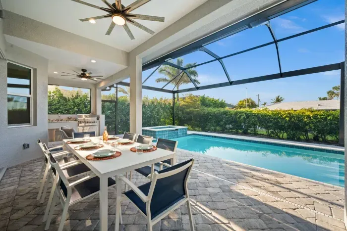 Outdoor Dining Oasis: Dine al fresco by the sparkling pool with a grill and garden views!