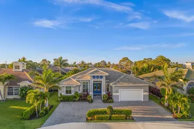 Exterior: Bright tropical oasis with lush landscaping and a welcoming entrance—your sunny escape awaits!