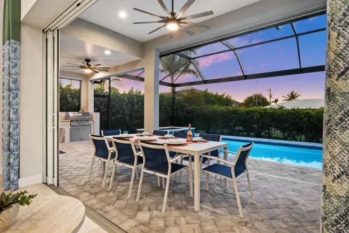 Outdoor Dining Area: Savor al fresco meals beside the sparkling pool and stunning sunset views!