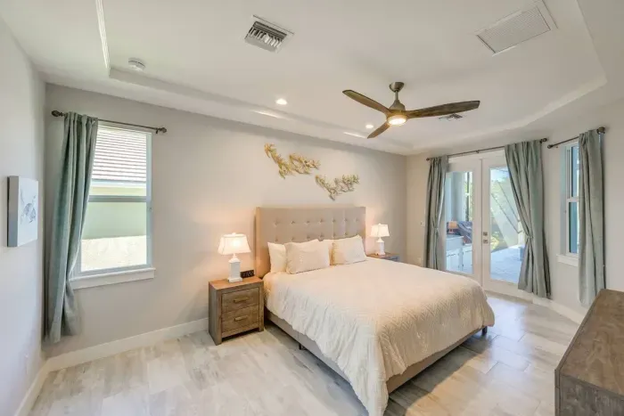 Master Bedroom: Stylish retreat with bright natural light and serene outdoor access awaits!
