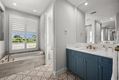 Master Bathroom: Sunlit retreat with elegant fixtures and a relaxing soaking tub for ultimate bliss!