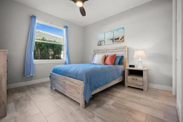 Bedroom Retreat: Bright, airy space with coastal decor and serene garden views awaits your relaxation!