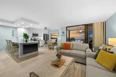 Living Room: Open layout with bay views, vibrant decor, and perfect for relaxation!