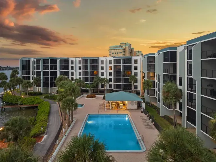 Poolside Paradise: Relax by the shimmering heated pool surrounded by lush landscapes and bay views!