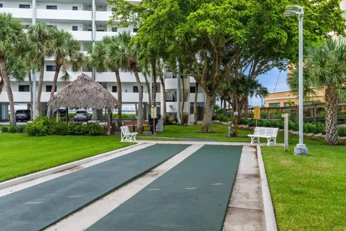 Shuffleboard Court: Enjoy fun games and shaded relaxation in a lush tropical setting!