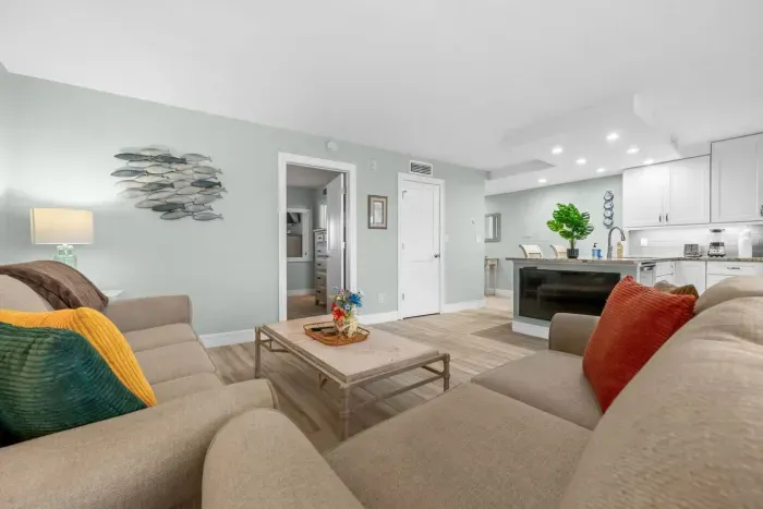 Living Room: Bright, beachy retreat with vibrant decor and open flow to the kitchen. Perfect for relaxing!