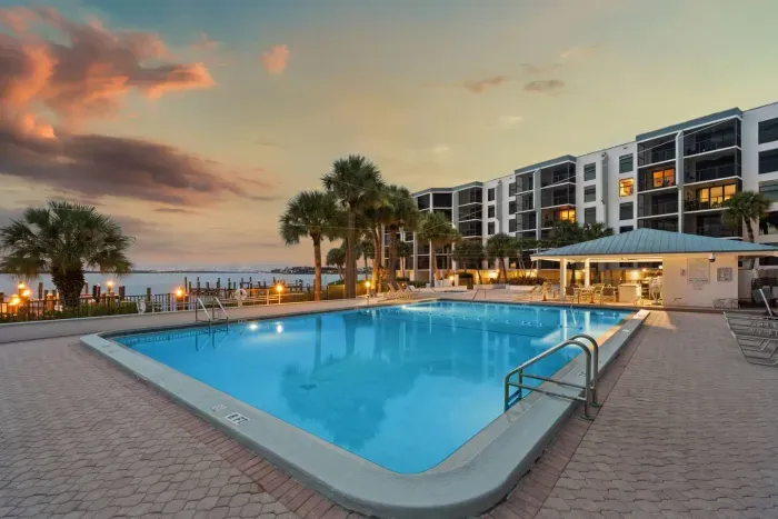 Heated Pool Paradise: Sparkling blue waters and palm trees await your ultimate relaxation!