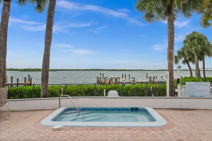 Spa Retreat: Unwind in the hot tub with stunning water views and tropical vibes!