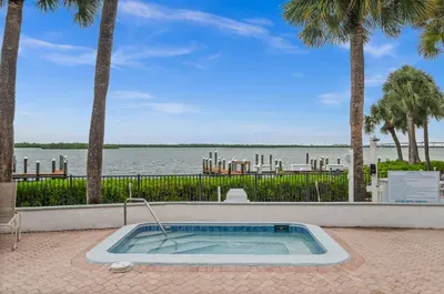 Spa Retreat: Unwind in the hot tub with stunning water views and tropical vibes!