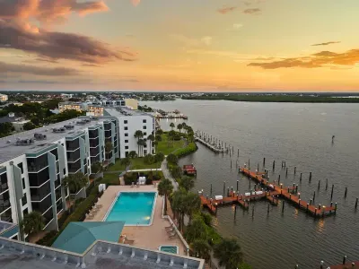 Exterior View: Breathtaking sunrise views over the bay, poolside relaxation awaits!
