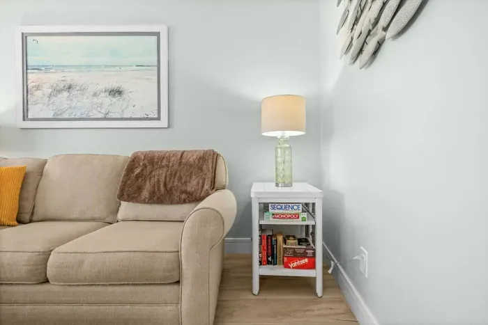Living Room: Relax with a beachy vibe, comfy couch, and playful games at your fingertips!