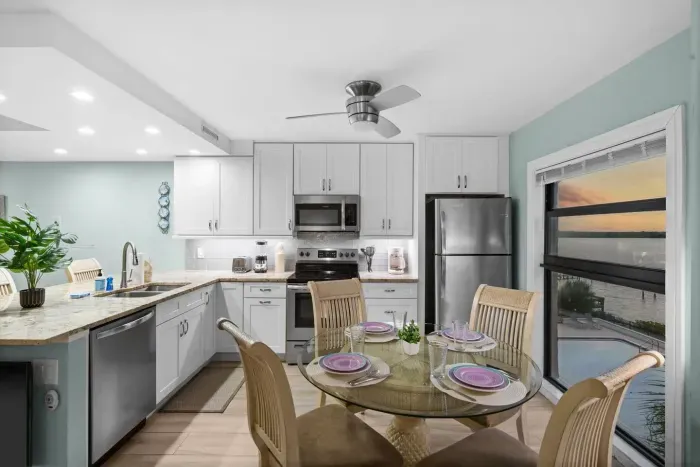 Dining Area: Enjoy sunset views while savoring meals at this stylish glass-top dining table!