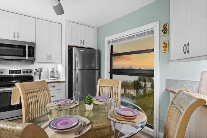 Dining Room: Enjoy the views while dining with a modern flair and beachy decor!