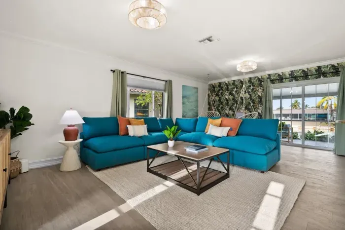Living Room: Vibrant hues and tropical decor create the perfect retreat for relaxation and fun!