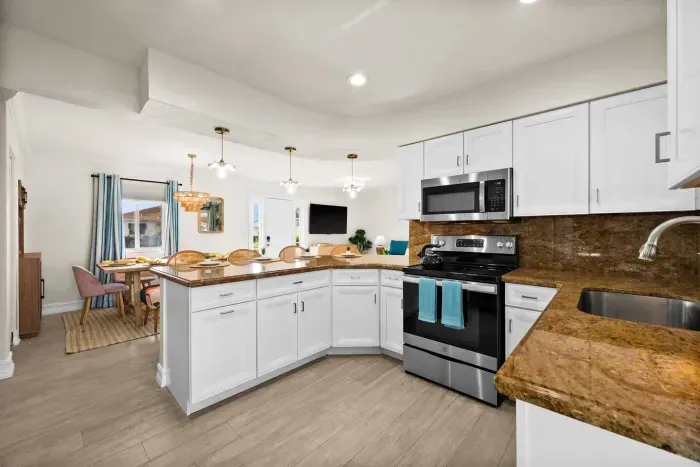 Kitchen Delight: Modern appliances meet chic design in this bright, open kitchen paradise!