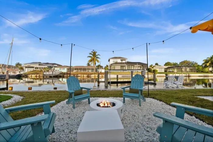 Outdoor Oasis: Gather around the fire pit with stunning water views and twinkling string lights!