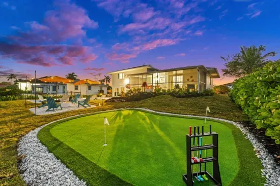 Outdoor Oasis: Perfect your putt in the lush yard, surrounded by stunning sunset views!